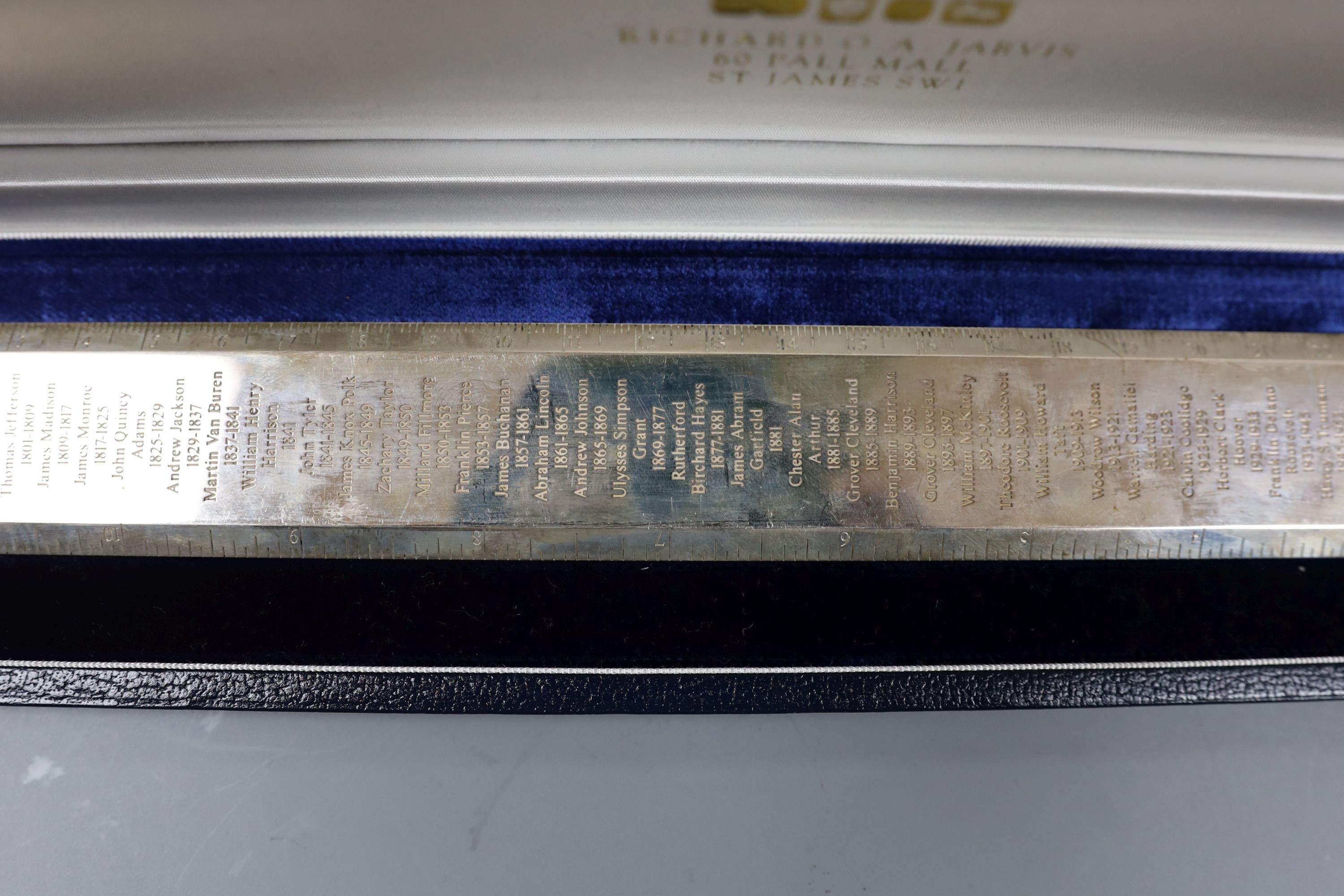 A cased modern silver 'Presidents Rule' ruler, engraved with the names and dates of US Presidents, by Richard Jarvis, London, 2004, 10oz